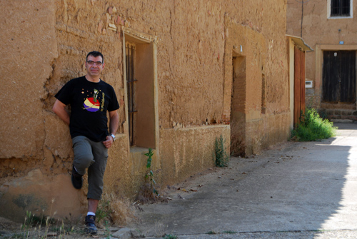 Raúl Gómez apoyado en las paredes de arquitectura popular de Urones. © Fotografía: Tor.