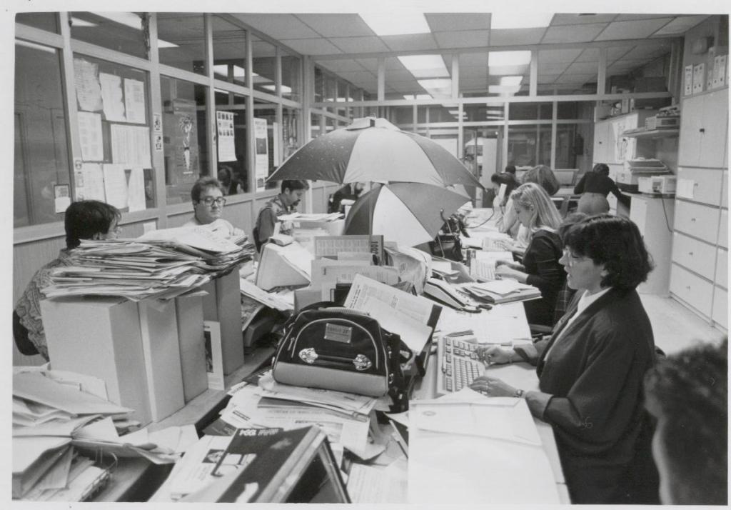 La redacción, con paraguas, en los tiempos en los que había goteras en la sede de Papalaguinda. 